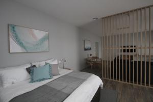a bedroom with a large bed and a table at Waterfront Apartments in Devonport