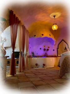 a bedroom with a bed and a tub in a room at Casas cueva El Castaño in Pampaneira