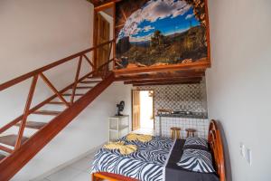 a room with a bed and a staircase at Pousada Raio de Sol in Lençóis