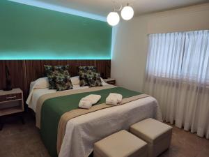 a hotel room with two beds with towels on them at PUNTO SUR HOTEL BOUTIQUE in Malargüe