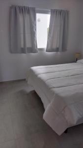 a bedroom with two beds and a window at Bahia sin fondo in Puerto Madryn