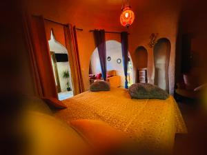 a bedroom with a bed with two pillows on it at Casas cueva El Castaño in Pampaneira