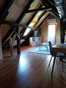 ein Wohnzimmer mit Holzboden und einem Tisch in der Unterkunft Family friendly house with a swimming pool Mihalic Selo, Karlovac - 20284 in Duga Resa