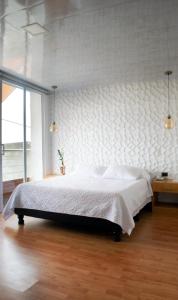 a bedroom with a large bed with a wall at Cucaña Hotel in El Pedregal +39 photos