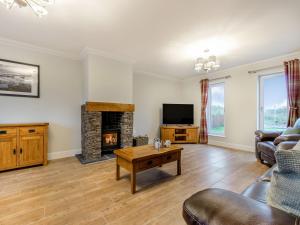 a living room with a couch and a fireplace at Iora Rua-uk40006 in Gartmore