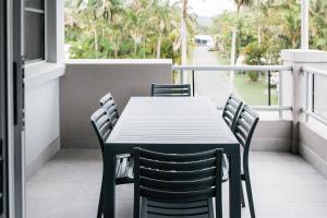 a black table and chairs on a balcony at Tasman Holiday Parks - North Star in Hastings Point