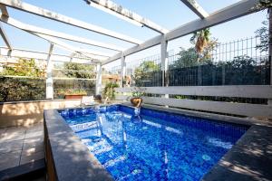 a swimming pool with a pergola on a house at Berenice Winery Hotel in Tiberias