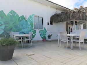 a patio with tables and chairs in front of a white building at Art Villa in Punta Cana