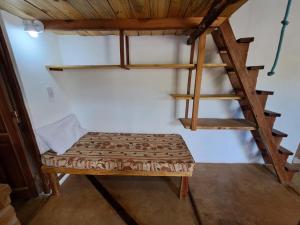 a room with a bunk bed and a ladder at La Mungana in Cafayate
