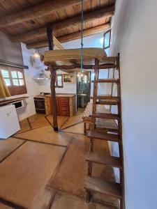 a room with a loft bed and a ladder at La Mungana in Cafayate