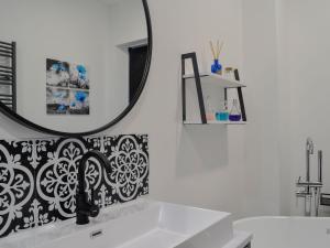 a bathroom with a sink and a mirror at Nith Villa in Dumfries