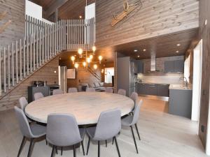 a dining room with a table and chairs and a kitchen at 12 person holiday home in IDRE-By Traum in Idre