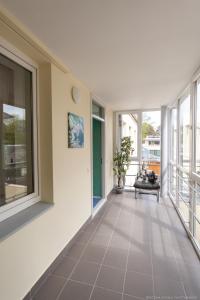 a hallway of a house with large windows at Apartamenti Alto & Ko in Jūrmala