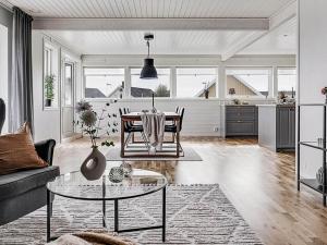 a living room with a table and a kitchen at 8 person holiday home in Lysekil-By Traum in Lysekil