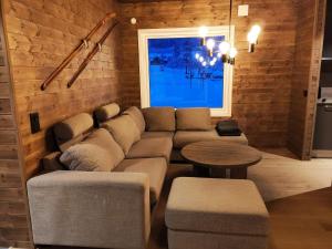 a living room with a couch and a table at 12 person holiday home in IDRE in Idre