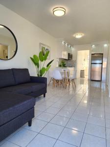 a living room with a couch and a kitchen at San Juan Apartments in San Juan