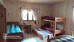 a bedroom with two bunk beds and a desk at Casa de la Oma in Ruiz de Montoya +18 photos