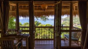 a view from the front door of a room with a balcony at Elang Hillside Bamboo Villas in Labuan Bajo