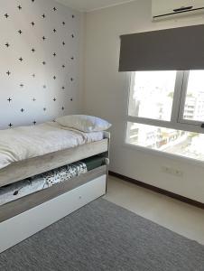 a bedroom with a bed with black stars on the wall at Corrientes Pora in Corrientes