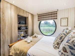 a bedroom with a large bed and a window at Oak Tree Lodge in Stoke Fleming