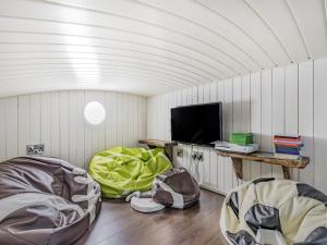 a room with two chairs and a tv in it at Oak Tree Lodge in Stoke Fleming