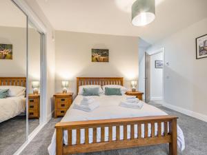 a bedroom with two beds and two night stands at Fiadh Ruadh-uk40008 in Gartmore