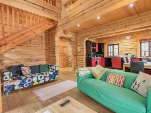 a living room with a green couch in a log cabin at Ty Ceirios - Uk42100 in Carno