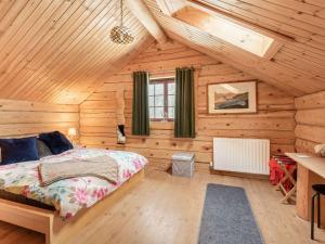 a bedroom with a bed in a wooden cabin at Ty Ceirios - Uk42100 in Carno