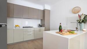 a white kitchen with a plate of food on a counter at Bluebell in Bowral