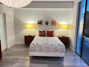 a bedroom with a bed with two lamps on both sides at Hollywood Homes minutes to everything SPACIOUS AND FREE PARKING in Los Angeles