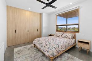 a bedroom with a bed and a window at REFLECTIONS at Lonsdale in Point Lonsdale