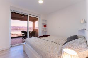 sypialnia z łóżkiem i widokiem na ocean w obiekcie Apartment Losacker w mieście Vir
