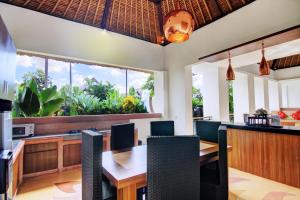 a dining room with a table and chairs at Villa Seminyak Estate & Spa - By Astadala in Seminyak