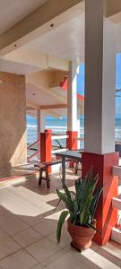 a patio with a table and a potted plant at Vista Aurora in Baler