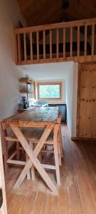 a large wooden table in the middle of a room at Mariposa - Cabañas Puerto del Zopilote in Pinal de Amoles