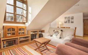 ein Wohnzimmer mit einer weißen Couch und einem Tisch in der Unterkunft Ático B Residencial Caldares El Pueyo in El Pueyo de Jaca