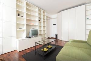 ein Wohnzimmer mit einem Sofa und einem TV in der Unterkunft De Lellis in Turin