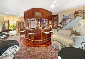 a living room with a piano and a bar at Montville Boutique BnB in Montville