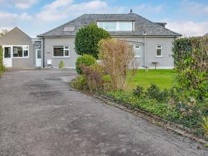 a house with a driveway in front of it at Westville in Criccieth