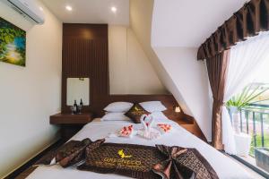 Postel nebo postele na pokoji v ubytování GREENECO DA LAT HOTEL - Khách sạn Green Eco Đà Lạt