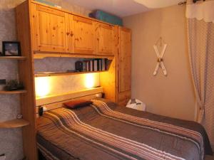 a bedroom with a bed with a wooden cabinet at Appartement Bagnères-de-Luchon, 2 pièces, 6 personnes - FR-1-313-218 in Luchon