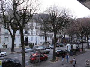 a group of people walking down a city street with cars at Appartement Bagnères-de-Luchon, 2 pièces, 6 personnes - FR-1-313-218 in Luchon