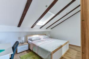 a bedroom with a bed and a desk and a window at Apartments Medved in Vir
