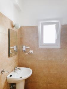 a bathroom with a sink and a window at Villa Elpiniki in Troulos