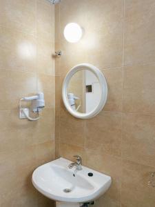 a bathroom with a sink and a mirror at Villa Elpiniki in Troulos