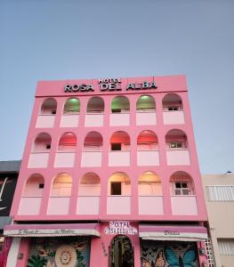 a pink building with a sign on it at Hotel Rosa del Alba in Chetumal