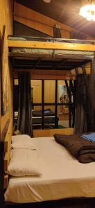 a bedroom with two bunk beds in a room at Into The Wild Stays in Dhanaulti