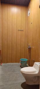 a bathroom with a toilet and a shower at Into The Wild Stays in Dhanaulti