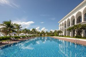 a swimming pool in front of a building at Meliá Vinpearl Cam Ranh Beach Resort in Cam Ranh
