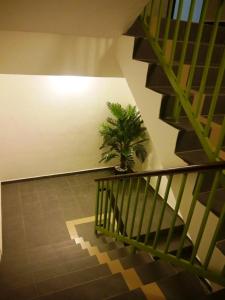 a staircase with a potted plant in a room at Hotel Wawasan in Simpang Renggam